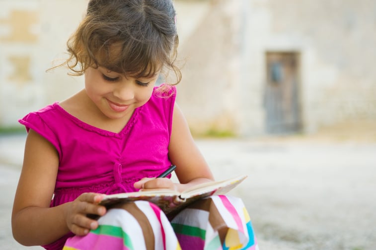 girl-writes-in-notebook-outside-2026-03-11-00-57-43-utc